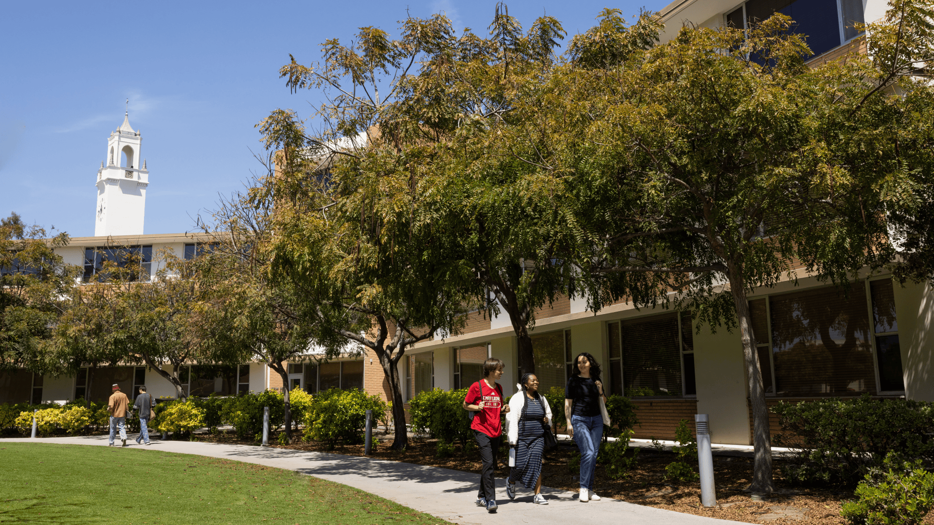 Students walking on LMU campus in front of Sacred Heart Chapel